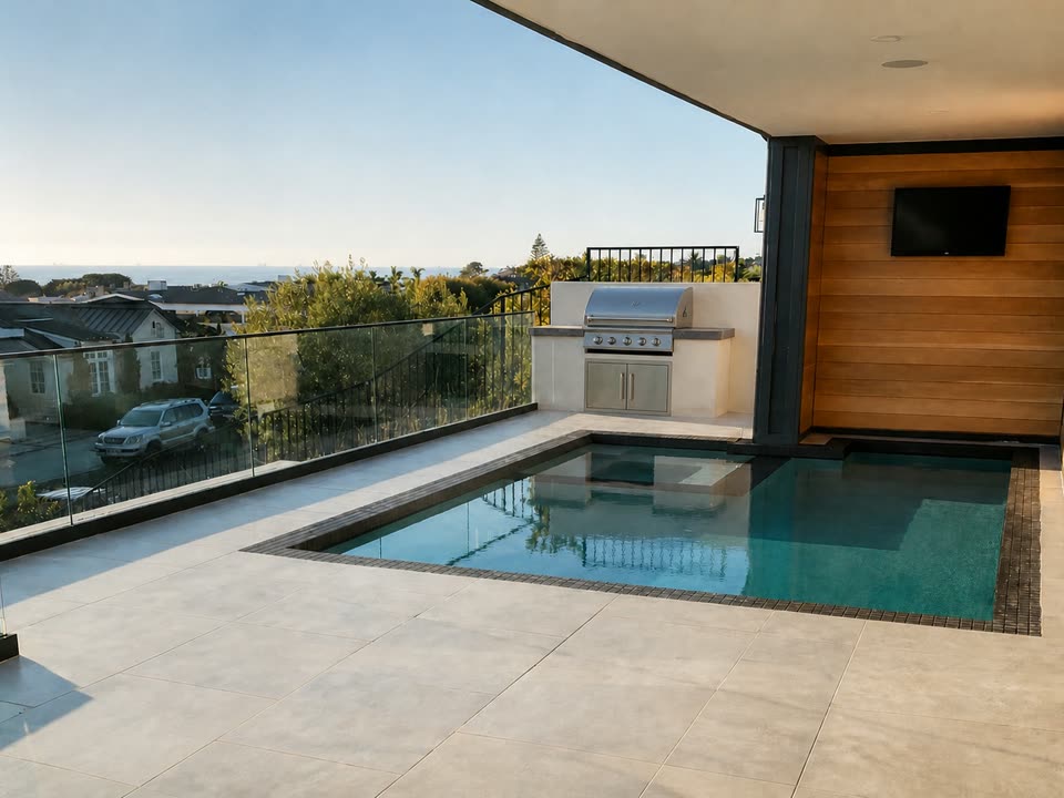 Elevated terrace pool with glass railing, built-in BBQ and ocean views in Corona del Mar, CA