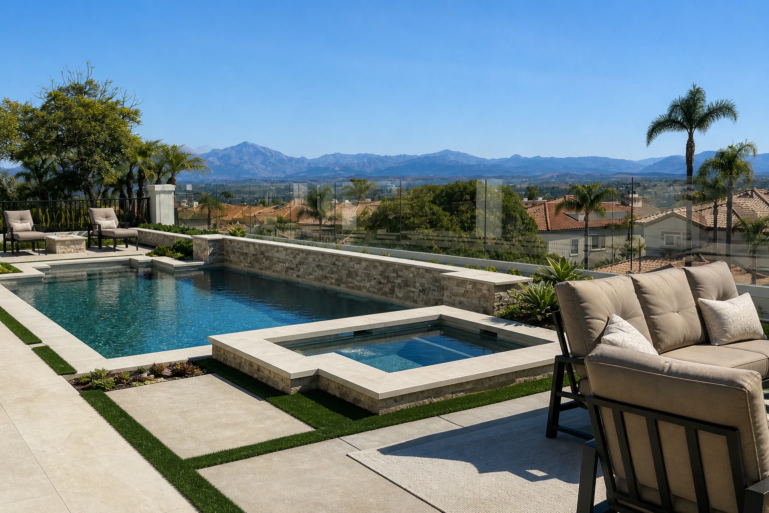 Pool and spa with turf-lined paver deck, lounge seating and mountain views in Laguna Niguel, CA
