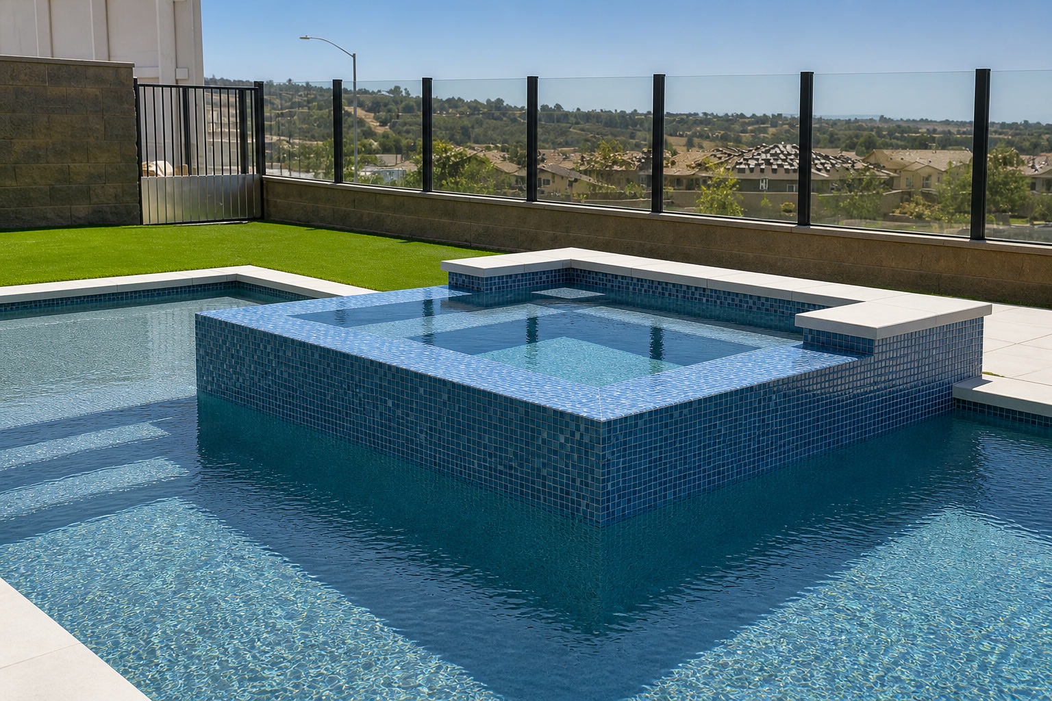 Raised spa clad in blue glass mosaic tile with white coping and hillside views in Portola Hills, CA