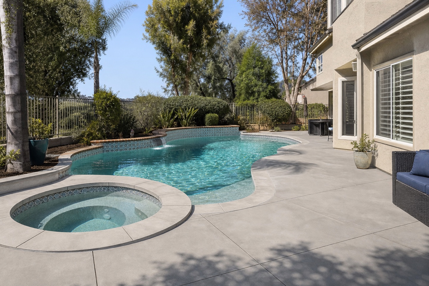 Renovated freeform pool and spa with new finishes and decking in South Orange County